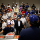 Wholesalers take part in an auction at the greengrocery area on the opening day of the new Toyosu market.